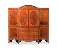 A SATINWOOD AND CROSSBANDED BREAKFRONT WARDROBE OR COMPACTUM, FIRST HALF 19TH CENTURY