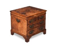 A GEORGE I WALNUT AND FEATHERBANDED BOX COMMODE, CIRCA 1725