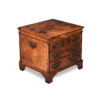 A GEORGE I WALNUT AND FEATHERBANDED BOX COMMODE, CIRCA 1725