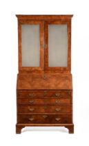 A GEORGE II WALNUT AND FEATHER BANDED BUREAU BOOKCASE, CIRCA 1740