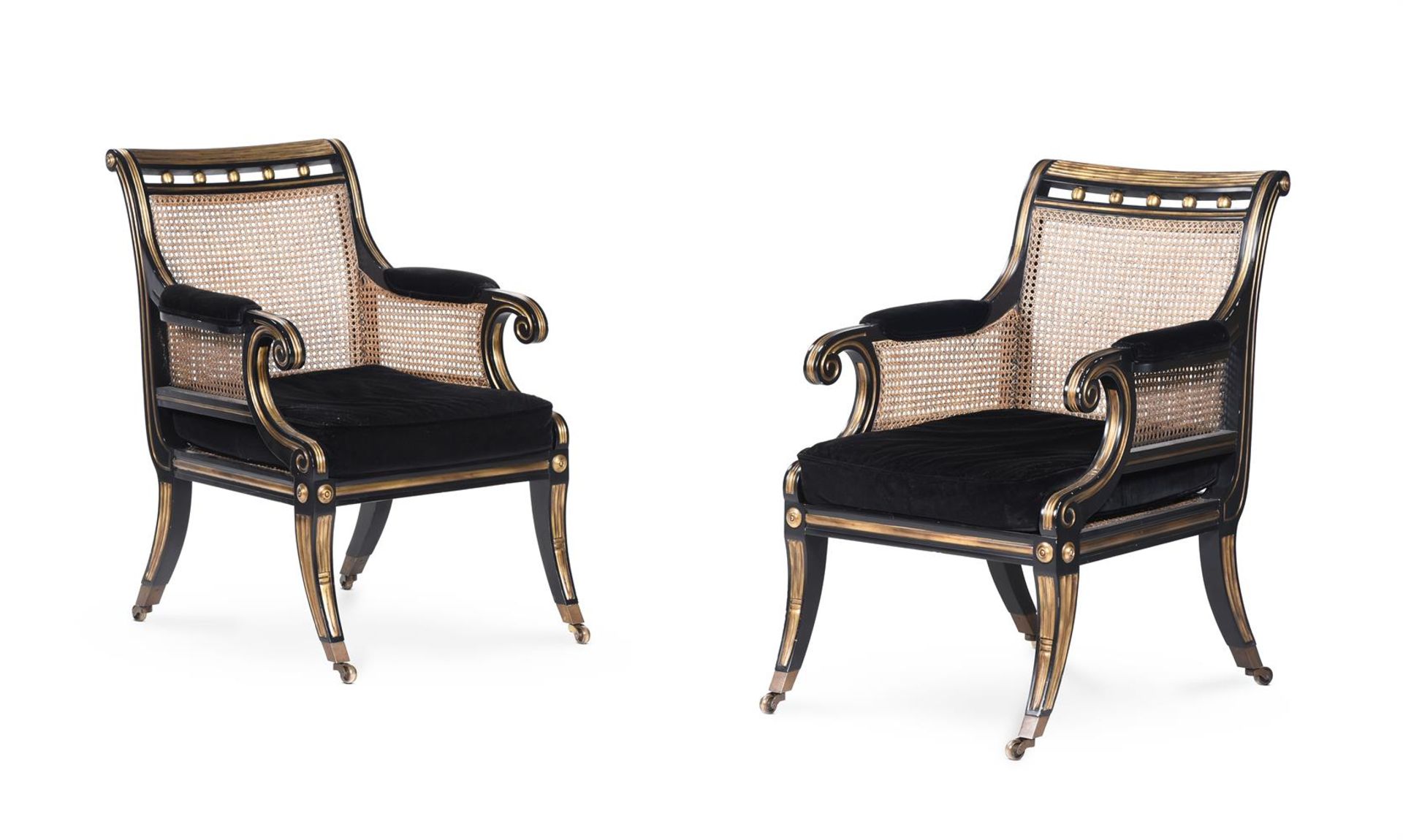 A PAIR OF EBONISED AND PARCEL GILT LIBRARY ARMCHAIRS, IN REGENCY STYLE, OF RECENT MANUFACTURE