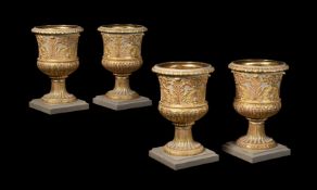 A SET OF FOUR CARVED WOOD, GESSO AND PARCEL GILT URNS, IN THE MANNER OF WILLIAM KENT