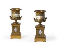 A PAIR OF FRENCH GILT BRONZE AND PAINTED PORCELAIN CLOCK GARNITURES, LATE 19TH CENTURY