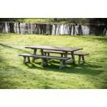 A LARGE TEAK GARDEN DINING TABLE AND A PAIR OF BENCHES, OF RECENT MANUFACTURE