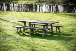 A LARGE TEAK GARDEN DINING TABLE AND A PAIR OF BENCHES, OF RECENT MANUFACTURE