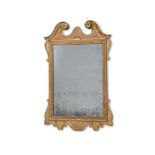 A GEORGE II CARVED GILTWOOD AND GESSO MIRROR, IN THE MANNER OF BENJAMIN GOODISON, CIRCA 1750