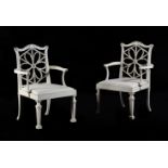 A SET OF TWELVE CREAM AND GREEN PAINTED DINING CHAIRS, IN THE MANNER OF THOMAS CHIPPENDALE