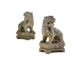 A PAIR OF CARVED STONE MODELS OF CHINESE LIONS, 20TH CENTURY