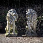 A PAIR OF COMPOSITION STONE MODELS OF SEATED LIONS, MODERN