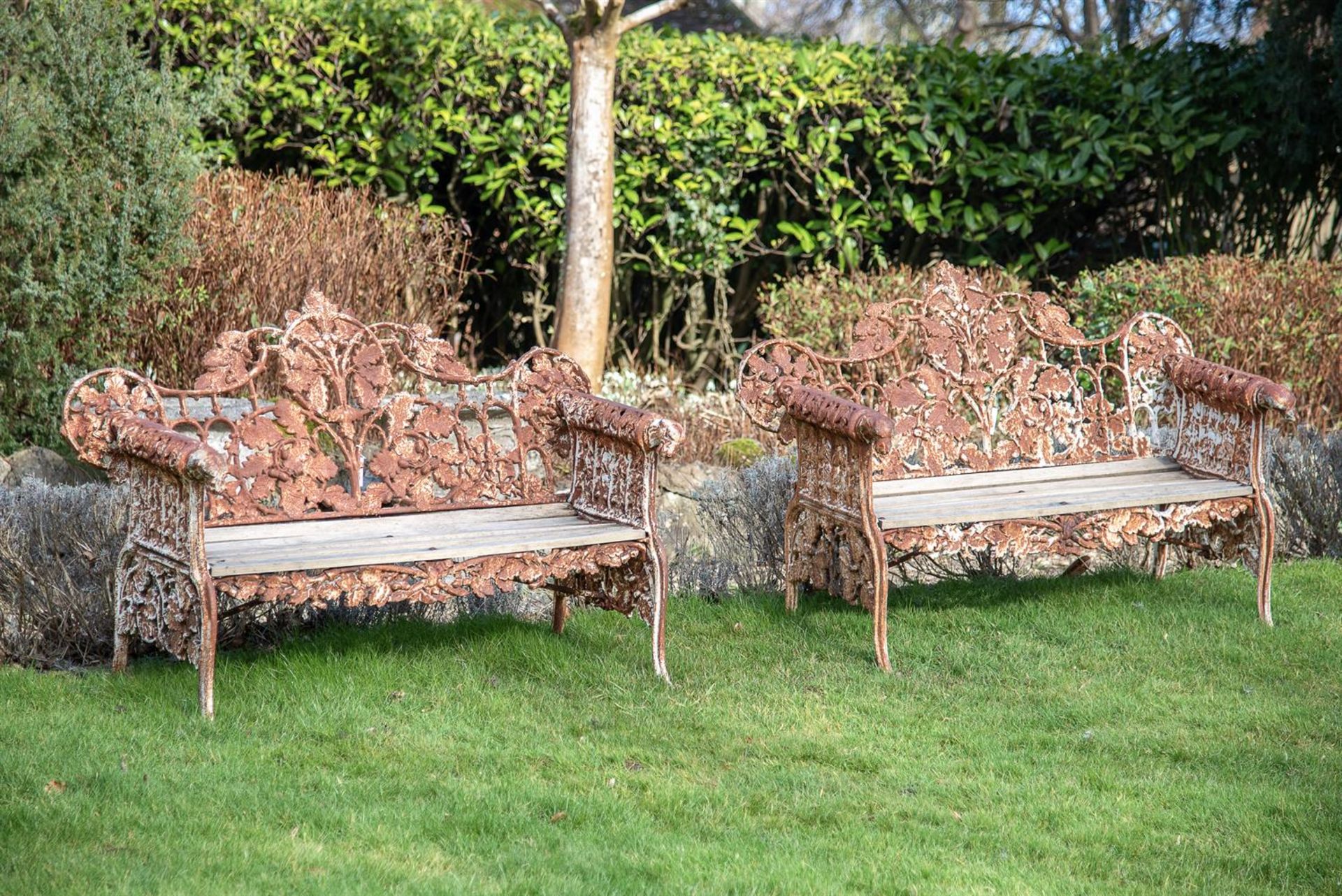 A PAIR OF CAST IRON GARDEN BENCHES IN THE COALBROOKDALE 'OAK AND IVY' PATTERN, 20TH CENTURY