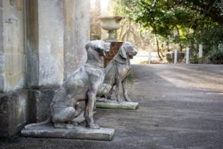 A PAIR OF COMPOSITION STONE ANIMALIER FIGURES OF SEATED DOGS, MODERN