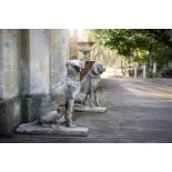 A PAIR OF COMPOSITION STONE ANIMALIER FIGURES OF SEATED DOGS, MODERN