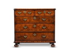 A QUEEN ANNE WALNUT AND FEATHER BANDED CHEST OF DRAWERS, CIRCA 1710
