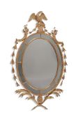 A GEORGE III CARVED GILTWOOD OVAL MIRROR, CIRCA 1780