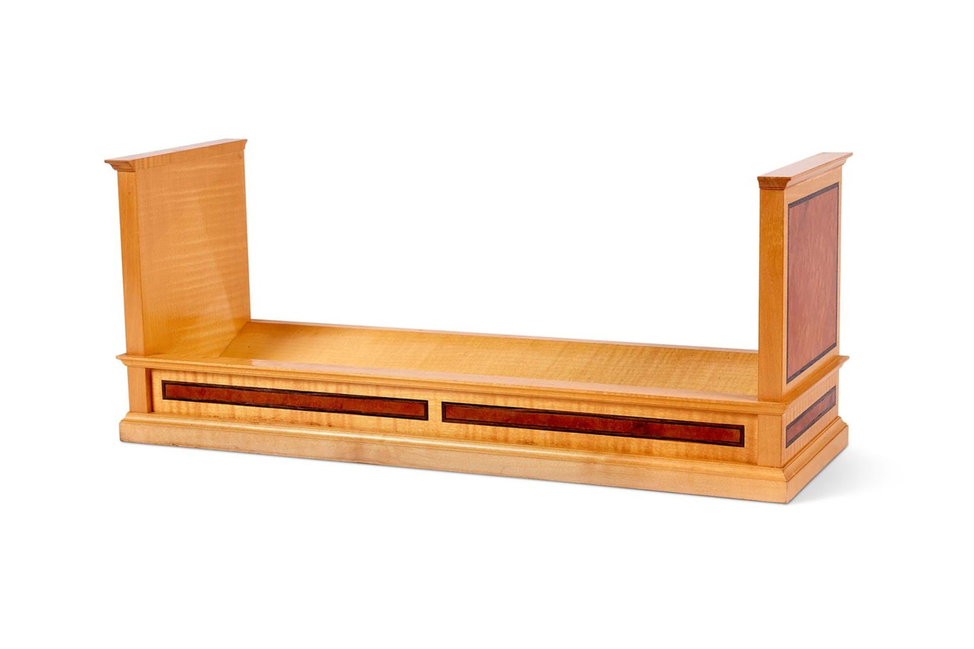 A SYCAMORE AND BURR WALNUT BOOK TROUGH BY LINLEY