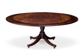 A MAHOGANY CONCENTRIC EXTENDING DINING TABLE IN THE MANNER OF JUPE