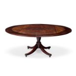 A MAHOGANY CONCENTRIC EXTENDING DINING TABLE IN THE MANNER OF JUPE