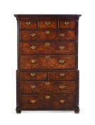 A GEORGE II WALNUT AND FEATHERBANDED CHEST ON CHEST, CIRCA 1740