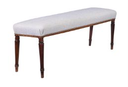 A MAHOGANY AND UPHOLSTERED WINDOW SEAT OR HALL BENCH IN REGENCY STYLE