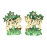 A PAIR OF STAFFORDSHIRE CREAMWARE/PEARLWARE BOCAGE MODELS OF TIGERS SECOND QUARTER 19TH CENTURY Mo