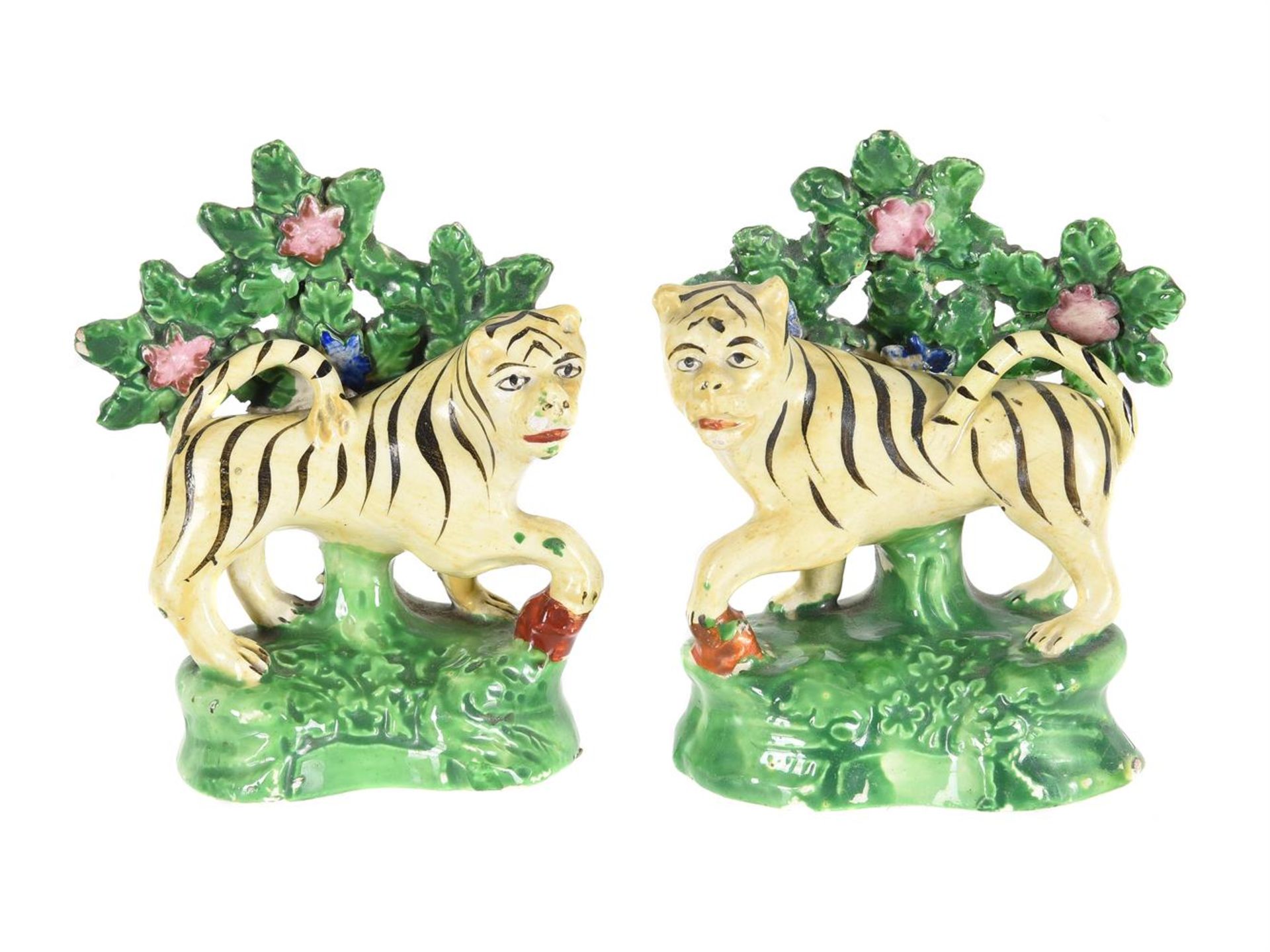 A PAIR OF STAFFORDSHIRE CREAMWARE/PEARLWARE BOCAGE MODELS OF TIGERS SECOND QUARTER 19TH CENTURY Mo