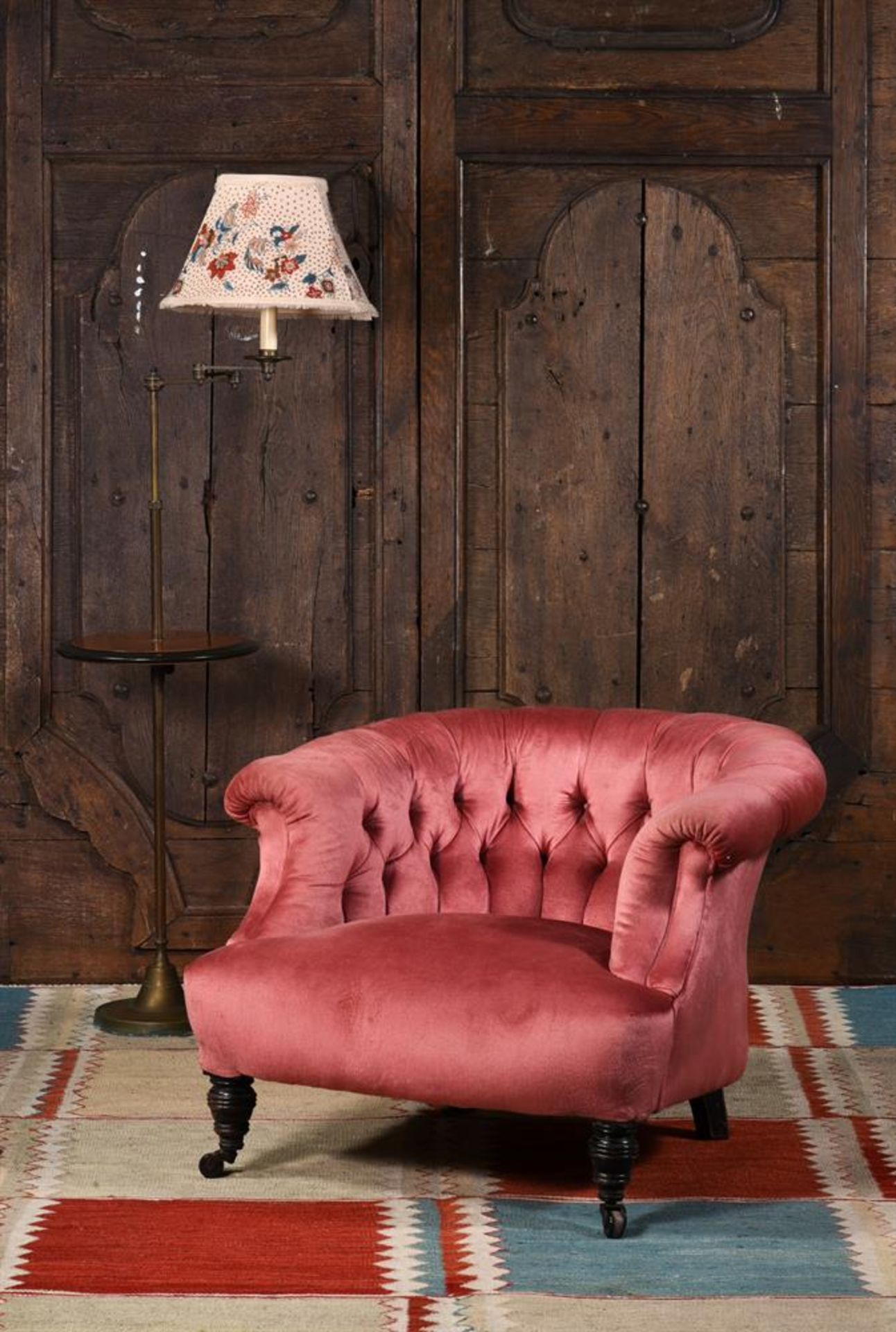 A VICTORIAN UPHOLSTERED LOW 'HORSESHOE' ARMCHAIR