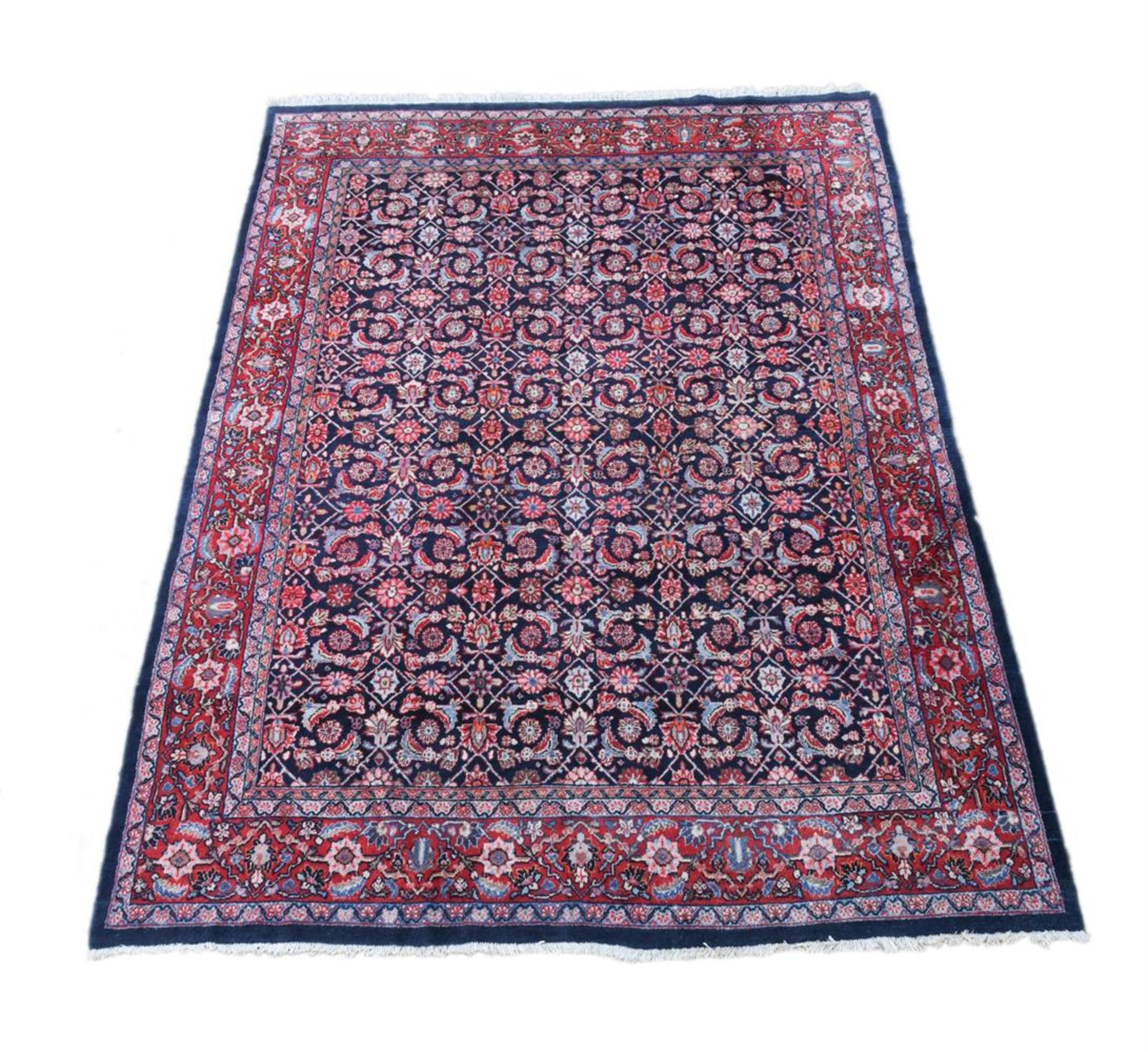 A PERSIAN WOOL CARPET IN HERATI STYLE