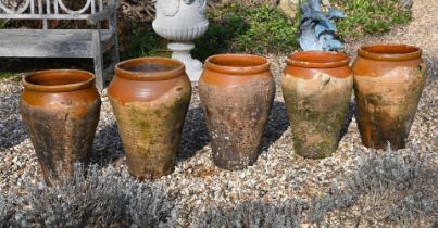 A GROUP OF FIVE VARIOUS TERRACOTTA AND PARCEL GLAZED OIL VESSELS, 20TH CENTURY