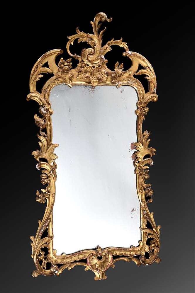 A CARVED GILTWOOD WALL MIRROR, IN IRISH GEORGE II STYLE