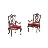 A PAIR OF IBERIAN CARVED WALNUT OPEN ARMCHAIRS IN 18TH CENTURY STYLE