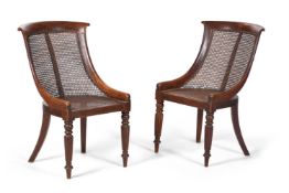 A PAIR OF GEORGE IV OAK LIBRARY BERGERE CHAIRS