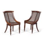 A PAIR OF GEORGE IV OAK LIBRARY BERGERE CHAIRS