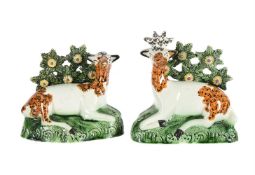 A PAIR OF ENGLISH PEARLWARE BOCAGE GROUPS OF A RECUMBANT STAG AND DOE