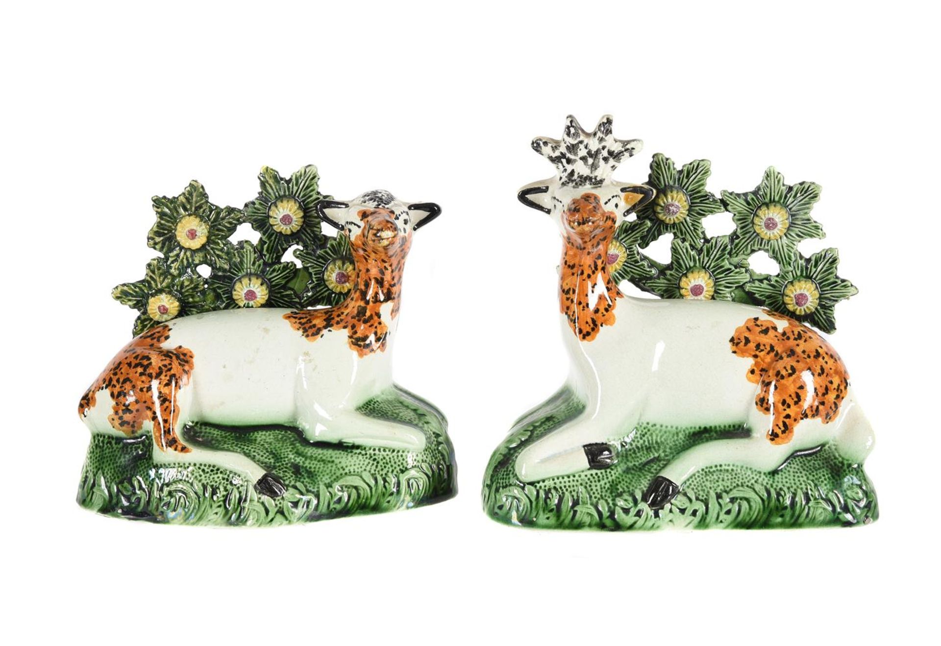 A PAIR OF ENGLISH PEARLWARE BOCAGE GROUPS OF A RECUMBANT STAG AND DOE