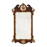 A GEORGE II WALNUT AND PARCEL GILT WALL MIRROR