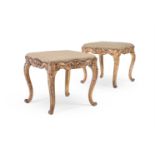 A PAIR OF CONTINENTAL CARVED GILTWOOD STOOLS