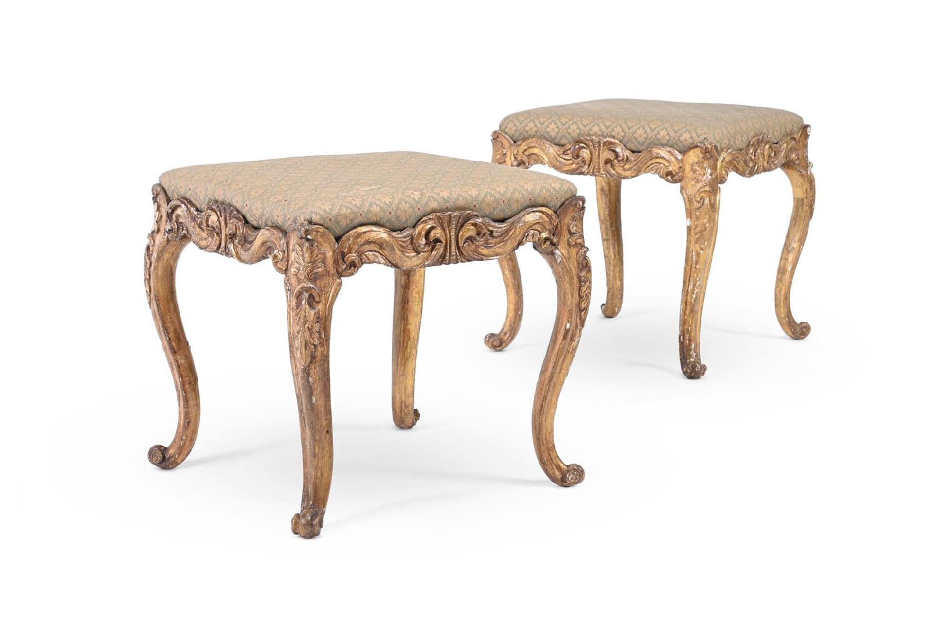 A PAIR OF CONTINENTAL CARVED GILTWOOD STOOLS