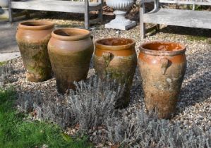 A GROUP OF FOUR VARIOUS TERRACOTTA AND PARCEL GLAZED OIL VESSELS, 20TH CENTURY