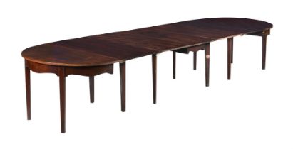 A MAHOGANY EXTENDING DINING TABLE