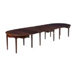 A MAHOGANY EXTENDING DINING TABLE