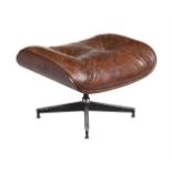AFTER CHARLES EAMES FOR HERMAN MILLER, A BROWN LEATHER UPHOLSTERED FOOTSTOOL