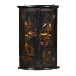A BLACK LACQUER AND GILT CHINOISERIE DECORATED HANGING CORNER CABINET