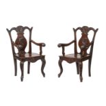 A PAIR OF CHINESE HARDWOOD CARVED ARMCHAIRS