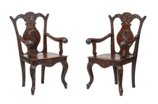A PAIR OF CHINESE HARDWOOD CARVED ARMCHAIRS