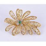 A DIAMOND AND EMERALD ABSTRACT FLOWER HEAD BROOCH/PENDANT