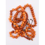 Y THREE AMBER PRAYER BEADS