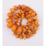 AN AMBER COLOURED BEAD NECKLACE