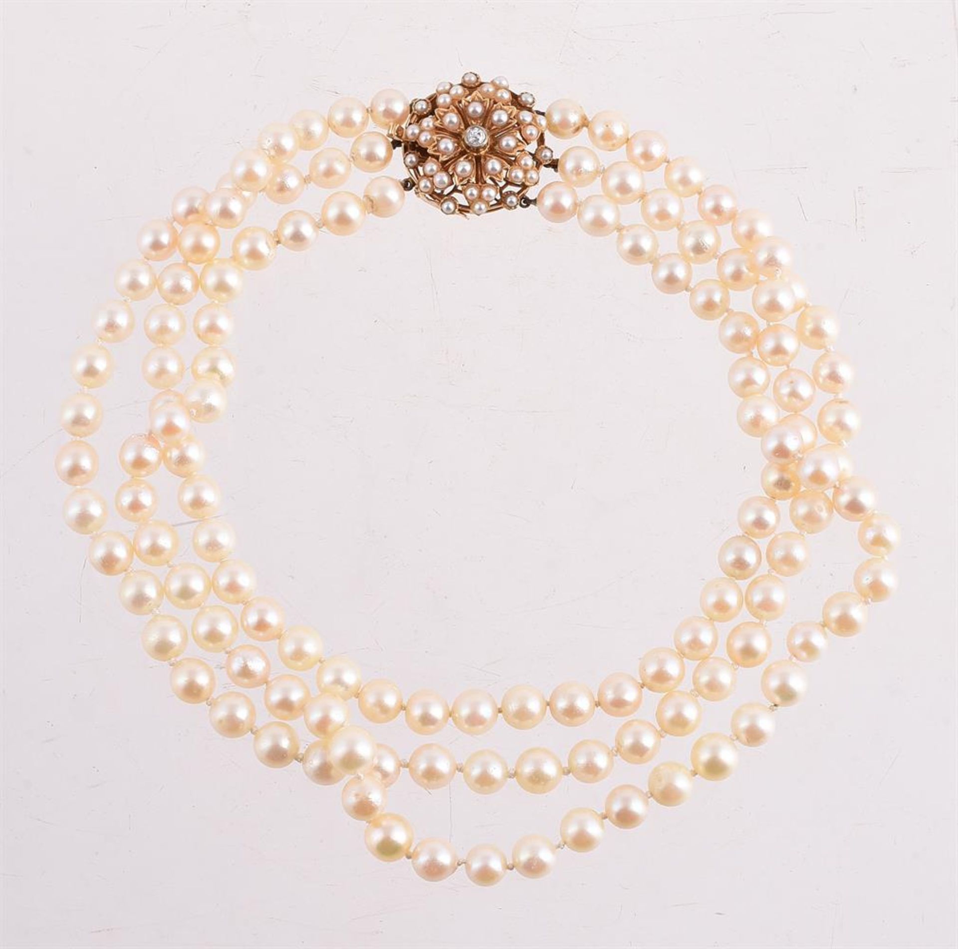 A THREE ROW CULTURED PEARL NECKLACE WITH A DIAMOND AND HALF CULTURED PEARL CLASP, LONDON 1988