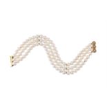 A FRENCH THREE STRAND CULTURED PEARL BRACELET WITH A DIAMOND CLASP