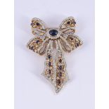 A SAPPHIRE AND DIAMOND PIERCED BOW BROOCH